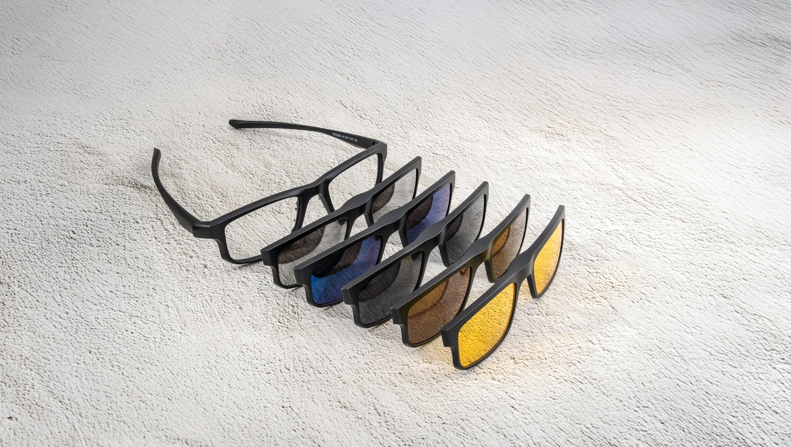 Glasses with different tinted lens attachments.